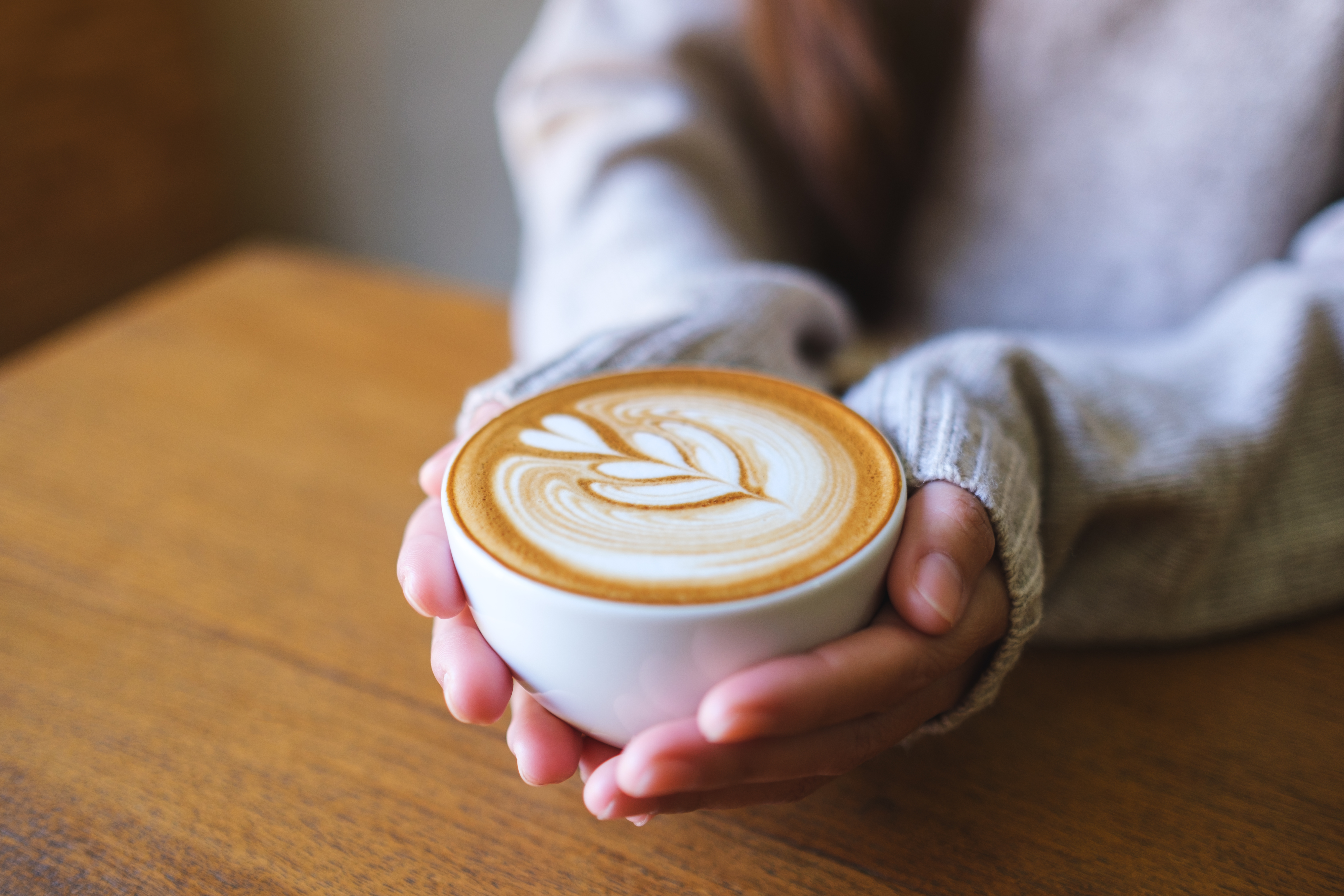 Latte art served in a white coffee cup